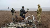 Deminers of the charitable fund 'Demining of Ukraine' use metal detectors to search for mines in the field near the town of Derhachi, Kharkiv region, on March 19, 2024, amid the Russian invasion of Ukraine. Photo Credit: SERGEY BOBOK / AFP.