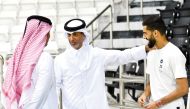 Minister of Sports and Youth H E Sheikh Hamad bin Khalifa bin Ahmed Al Thani with former Qatar captain Hassan Al Haydos (right), who recently retired from international football, on the sidelines of Qatar’s training session at Jassim Bin Hamad Stadium, yesterday. 