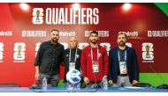 Qatar coach Marquez Lopez (second left) and midfielder Mohammed Waad (second right) pose for a photo after the press conference.