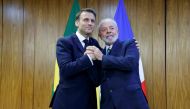 Brazil's President Luiz Inacio Lula da Silva (right) and France's President Emmanuel Macron pose for a picture during a bilateral agreement signing ceremony at the Planalto Palace in Brasilia on March 28, 2024. (Photo by Ludovic Marin / POOL / AFP)