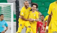 Al Gharafa's Ahmed Alaaeldin (centre) celebrates with captain Yacine Brahimi after scoring a goal against Al Arabi, yesterday.