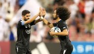 Al Sadd's captain Hassan Al Haydos congratulates Akram Afif after the latter scored their first goal.