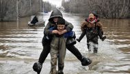 Taken on April 8, 2024 shows rescuers evacuating residents from the flooded part of the city of Orsk, Russia's Orenburg region, southeast of the southern tip of the Ural Mountains. Photo by Anatoliy ZHDANOV / Kommersant Photo / AFP.