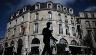 This photograph taken on April 10, 2024 shows a pedestrian walking past a hotel in Bordeaux, southwestern France. Photo by Philippe LOPEZ / AFP
