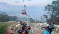 Photograph taken and released on April 12, 2024 by Turkish news agency DHA (Demiroren News Agency) shows rescue teams conducting a rescue operation and helping injured people after a cable car cabin crashed into a fallen cable pole in Konyaalti district of Antalya. Photo by Handout / DHA (Demiroren News Agency) / AFP. 