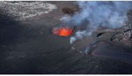 Picture taken with a drone on April 13, 2024 at Svartsengi near Grindavik, Iceland, shows an aerial view of a volcanic eruption at Sundhnukagigar in southwest Iceland, ongoing for a month. (Photo by Jeremie Richard / AFP) 
