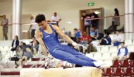 Gymnasts compete during the qualifying rounds yesterday. 