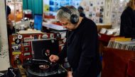 A customer listens to a vinyl at indie record store Flashback Records in London on April 18, 2024. (Photo by BENJAMIN CREMEL / AFP)