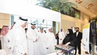 Undersecretary of the Ministry of Education and Higher Education Dr. Ibrahim bin Saleh Al Nuaimi (third left) and President of UDST Dr. Salem Al Naemi (fourth left) touring the exhibition pavillion during the event.