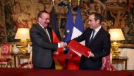 German Defence Minister Boris Pistorius (L) and France's Minister for the Armed Forces Sebastien Lecornu shake hands after signing a agreement on the joint MGCS 