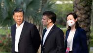 China's President Xi Jinping and France's President Emmanuel Macron are accompanied by an interpreter as they visit the garden of the residence of the Governor of Guangdong in Guangzhou on April 7, 2023. Photo by Jacques WITT / POOL / AFP.