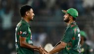 Bangladesh's Mustafizur Rahman (L) celebrates with Shakib Al Hasan after taking the wicket of Zimbabwe's Luke Jongwe (not pictured) during the fourth Twenty20 international cricket match between Bangladesh and Zimbabwe at the at Sher-e-Bangla National Cricket Stadium in Dhaka on May 10, 2024. (Photo by MUNIR UZ ZAMAN / AFP)
