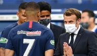 (Files) French President Emmanuel Macron (R) gestures as he speaks with Paris Saint-Germain's French forward Kylian Mbappe (L) at the Stade de France in Saint-Denis, outside Paris on July 24, 2020. (Photo by Franck Fife / AFP)