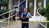 A Kosovan police officer guards an office of 