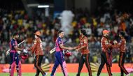 Sunrisers Hyderabad players (orange) are congratulated by Rajasthan Royals players after their win at the end of their IPL T20 second qualifier cricket match in the MA Chidambaram Stadium of Chennai on May 24, 2024. (Photo by R.Satish Babu / AFP) 
