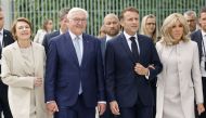 German President Frank-Walter Steinmeier (2ndL) and his wife Elke Buedenbender (L) walk with French President Emmanuel Macron (2ndR) and his wife Brigitte Macron (R) past the Chancellery on their way to attend a debate as part of the Festival of Democracy (Demokratiefest) on May 26, 2024 in Berlin. Photo by Ludovic MARIN / AFP.