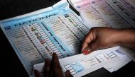 An Electoral Commission of South Africa (IEC) official prepares a ballot to be handed out to a voter during special voting at the Glebe Community Hall polling station in Umlazi on May 28, 2024 the day ahead of the South African elections scheduled for May 29, 2024. (Photo by GIANLUIGI GUERCIA / AFP)
