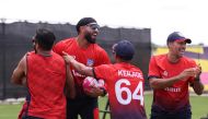 Members of the USA team celebrate a training win, during a net session as part of the ICC Men's T20 cricket World Cup West Indies & USA 2024 at Grand Prairie cricket Stadium on May 31, 2024 in Dallas, Texas. (Photo by Robert Cianflone/Getty Images/AFP)