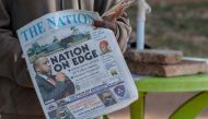 A newspaper vendor holds The Nation newspaper with a cover picture of the missing plane Vice State President Saulos Klaus Chilima in Lilongwe, on June 11, 2024. Photo by Amos Gumulira / AFP