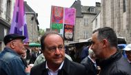 Former French president, member of French left-wing Socialist Party (PS) and candidate for the left wing coalition Nouveau Front Populaire (NFP) in the Correze department Francois Hollande meets local residents during a campaign visit, ahead of the upcoming legislative elections, in Ursel, central France on June 22, 2024. (Photo by Pascal LACHENAUD / AFP)
