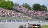 McLaren's British driver Lando Norris celebrates getting the pole position after the qualification session at the Circuit de Catalunya on June 22, 2024 in Montmelo, on the outskirts of Barcelona, during the Spanish Formula One Grand Prix. (Photo by Manaure Quintero / AFP)
