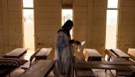 A voter prepares to mark his ballot at a voting station in Nouakchott on June 29, 2024. (Photo by JOHN WESSELS / AFP)
