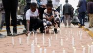 Kenyan youths light candles in memory of protesters killed during the nationwide deadly protest against a controversial now-withdrawn tax bill that left over 20 dead and shocked the East African nation, in Nairobi on June 30, 2024. (Photo by SIMON MAINA / AFP)
