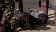 Detained protesters are seen doing push ups during an anti-government demonstration in downtown Nairobi, on July 2, 2024. (Photo by Kabir Dhanji / AFP)