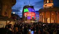An exit poll predicting that the Labour Party led by Keir Starmer will win 410 seats in Britain's general election is projected onto BBC Broadcasting House in London on July 4, 2024. Labour is set for landslide win in UK election, exit polls showed. (Photo by Oli SCARFF / AFP)

