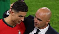 Portugal's forward Cristiano Ronaldo and head coach Roberto Martinez react at the end of the UEFA Euro 2024 quarter-final on July 5, 2024. (Photo by Ronny Hartmann / AFP)