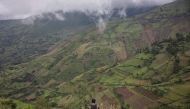 An Ethiopian soldier sits looking at the valley close to the scene of a landslide in Kencho Shacha Gozdi on July 26, 2024. (Photo by Michele Spatari / AFP)