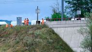 SNCF employees repair the scene of a suspected attack on the Eastern high speed railway network in Vandieres, north eastern France on July 26, 2024. (Photo by Jean-Christophe Verghaegen / AFP)