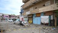 Damaged cars lie in a street in Port Sudan after torrential rains on August 1, 2024. (Photo by AFP)
