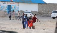 Relatives carry the body of a woman killed during an attack in Mogadishu on August 3, 2024. (Photo by Hassan Ali ELMI / AFP)
