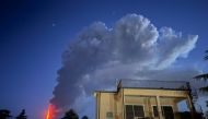 Lava, steam and ashes spew from a crater of the Mount Etna volcano early on August 4, 2024 in Sicily. (Photo by Giuseppe Distefano / Etna Walk / AFP)

