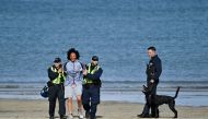Police officers arrest a masked protester during the 'Enough is Enough' demonstration called by far-right activists in Weymouth, on the southwest coast of England where the Bibby Stockholm migrant accommodation barge is moored, on August 4, 2024. (Photo by Justin Tallis / AFP)