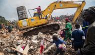 People look on as an excavator helps search for people trapped under debris after a landfill collapsed in Kampala on August 10, 2024. Photo by BADRU KATUMBA / AFP