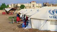 People already displaced by conflict, rest by tents at a makeshift campsite they were evacuated to following deadly floods in the eastern city of Kassala on August 11, 2024. (Photo by AFP)
