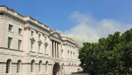 Smoke is seen rising into the sky from a fire located in the roof of Somerset House beside the River Thames in London on August 17, 2024. Photo by James RYBACKI / AFP