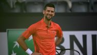 Serbia's Novak Djokovic smiles during his match against France's Corentin Moutet during the Men's ATP Rome Open tennis tournament at Foro Italico in Rome on May 10, 2024. (Photo by Filippo Monteforte / AFP)