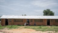 Children play outside of a classroom at the a school in Birao on August 12, 2024. Photo by Amaury Falt-Brown / AFP. 