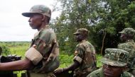 (FILES) Soldiers of the Uganda People's Defence Force (UPDF) patrol in Zemio, in the northeastern part of the Central African Republic to secure the area from rebel groups' possible attacks, on June 25, 2014. (Photo by Michele SIBILONI / AFP)
