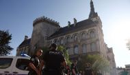 French police stand guard in front of the Town Hall after a man attempted to set the building alight with petrol in Angouleme on August 21, 2024. (Photo by Romain PERROCHEAU / AFP)
