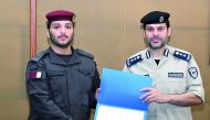 An officer being presented with the certificate at the end of the training.