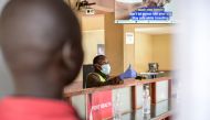A port health officer gives an all clear to a traveller at Malaba One Stop Border Post, a border crossing point between Kenya and Uganda in Malaba, western Kenya on August 20, 2024. Photo by Brian ONGORO / AFP. 