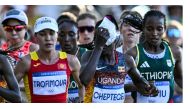 Uganda's Rebecca Cheptegei (C) applies an ice bag on her head as she competes in the women's marathon of the athletics event at the Paris 2024 Olympic Games in Paris on August 11, 2024. Photo by Kirill KUDRYAVTSEV / AFP.