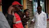 A woman reacts after visiting the burned dorm room at the Nyeri county's Hillside Endarasha Academy in Nyeri county on September 6, 2024. (Photo by Simon Maina / AFP)