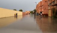 Residents walk on a flooded street in Morocco's Ouarzazate city on September 7, 2024. Photo by Abderahim ELBCIR / AFP