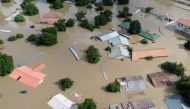 This aerial view shows houses submerged under water in Maiduguri on September 10, 2024. (Photo by Audu Marte / AFP)

