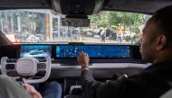 Photo used for demonstration purposes. Tech Specialist Raisu Williams demonstrates the media bar of the Sony Honda Mobility AFEELA prototype electric vehicle powered by Amazon Web Services on September 13, 2024 in Seattle, Washington. Photo by STEPHEN BRASHEAR / GETTY IMAGES NORTH AMERICA / Getty Images via AFP.